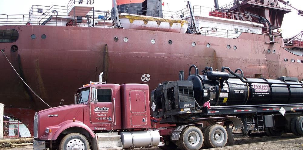 Bentley vacuum tanker beside a freighter